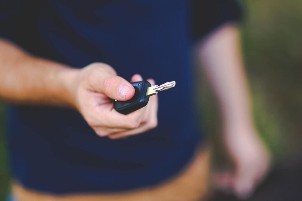 man holding car key